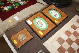 A pair of 19th Century oval porcelain plaques depi