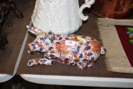 A Chinese porcelain sculpture of a pig, 33cm long