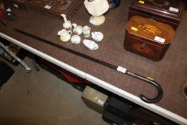 An antique ebonised walking cane with silver colla