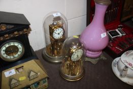 Two Anniversary clocks under glass domes