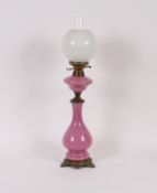 A Victorian pink opaque glass oil lamp of baluster