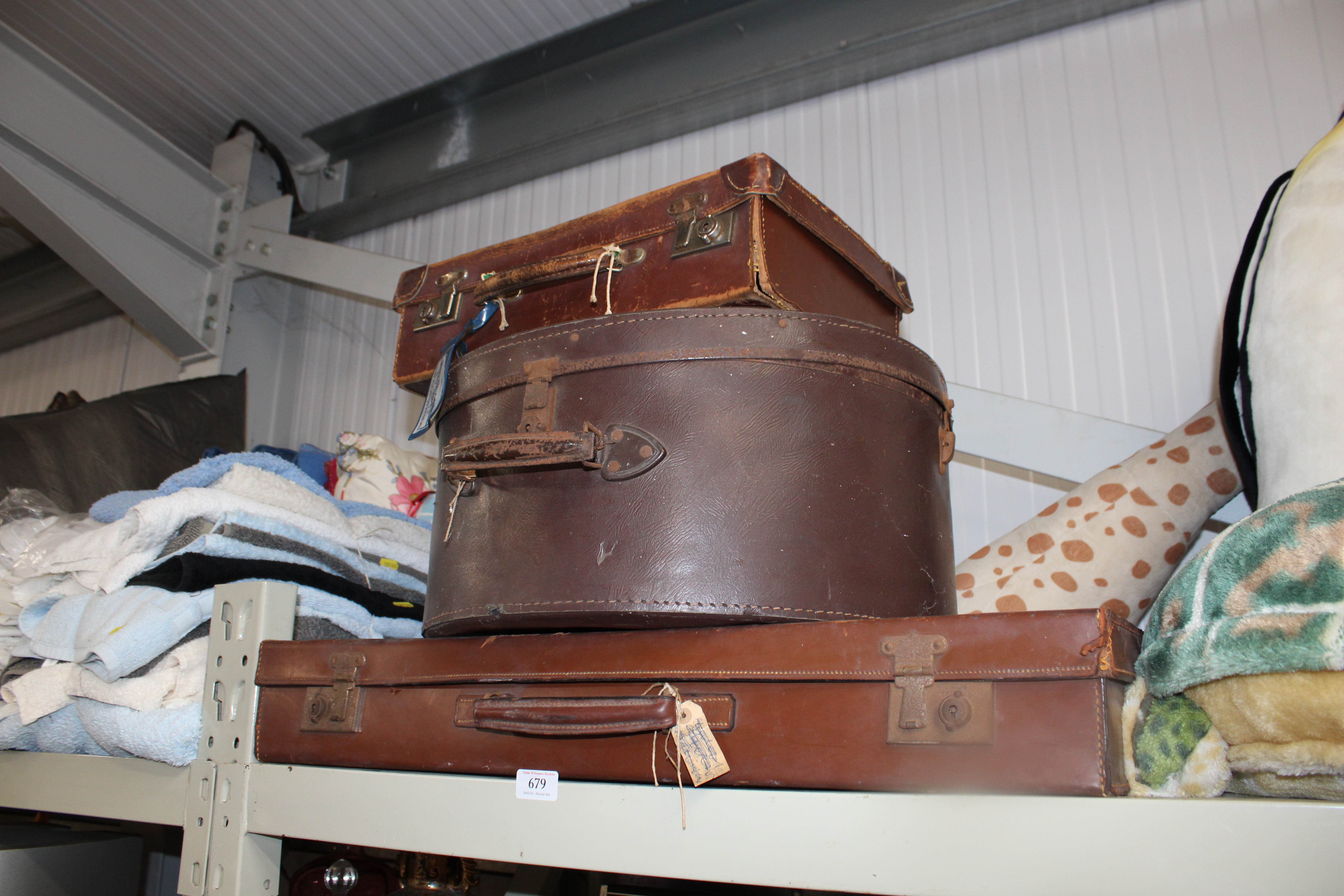 A vintage hat box together with two vintage suitca