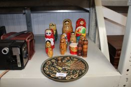 A quantity of wooden Russian dolls and a peacock d