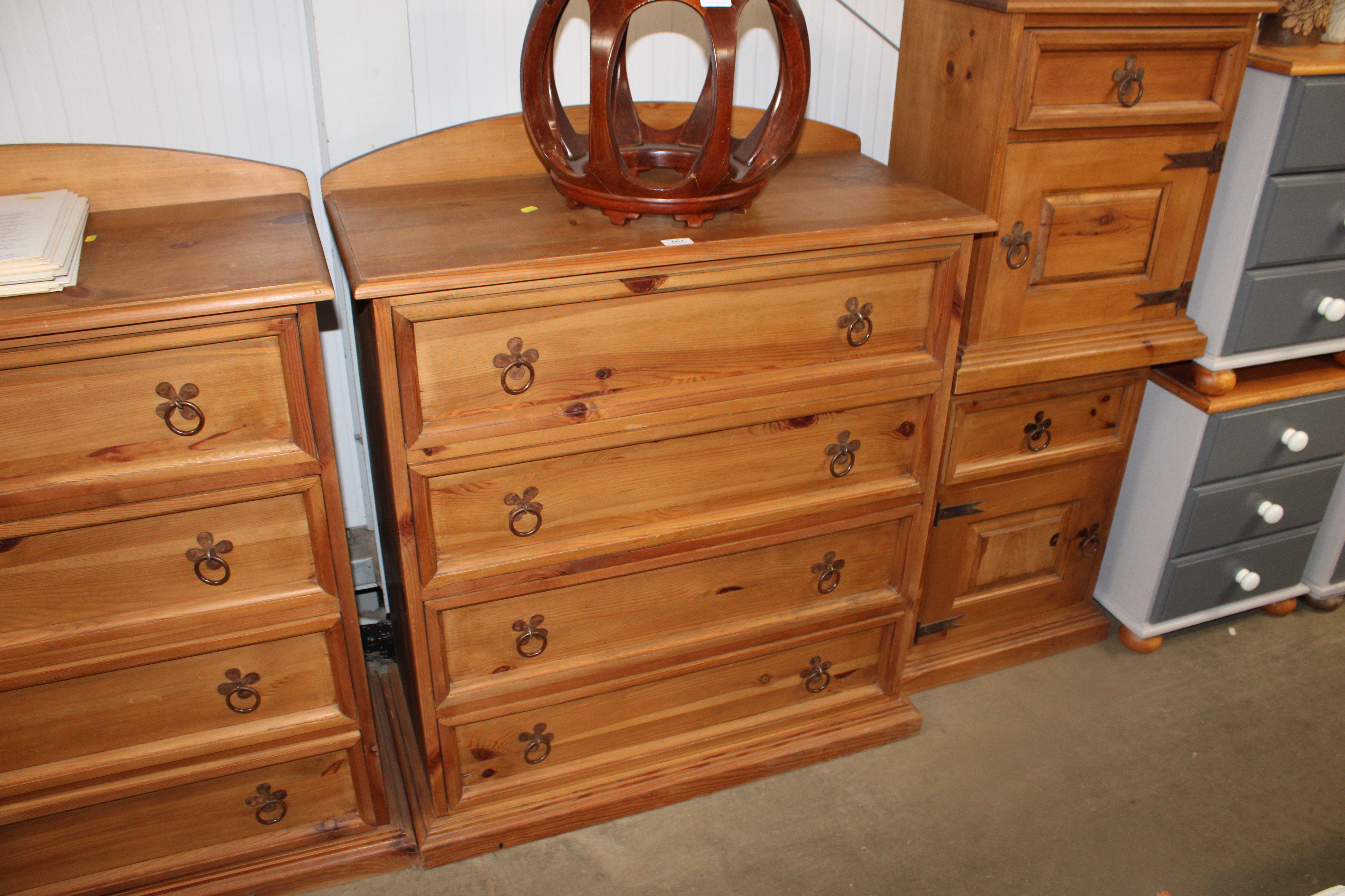 A pine chest fitted four long drawers having tile