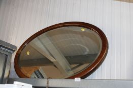 A mahogany and chequer band inlaid bevel edged wal
