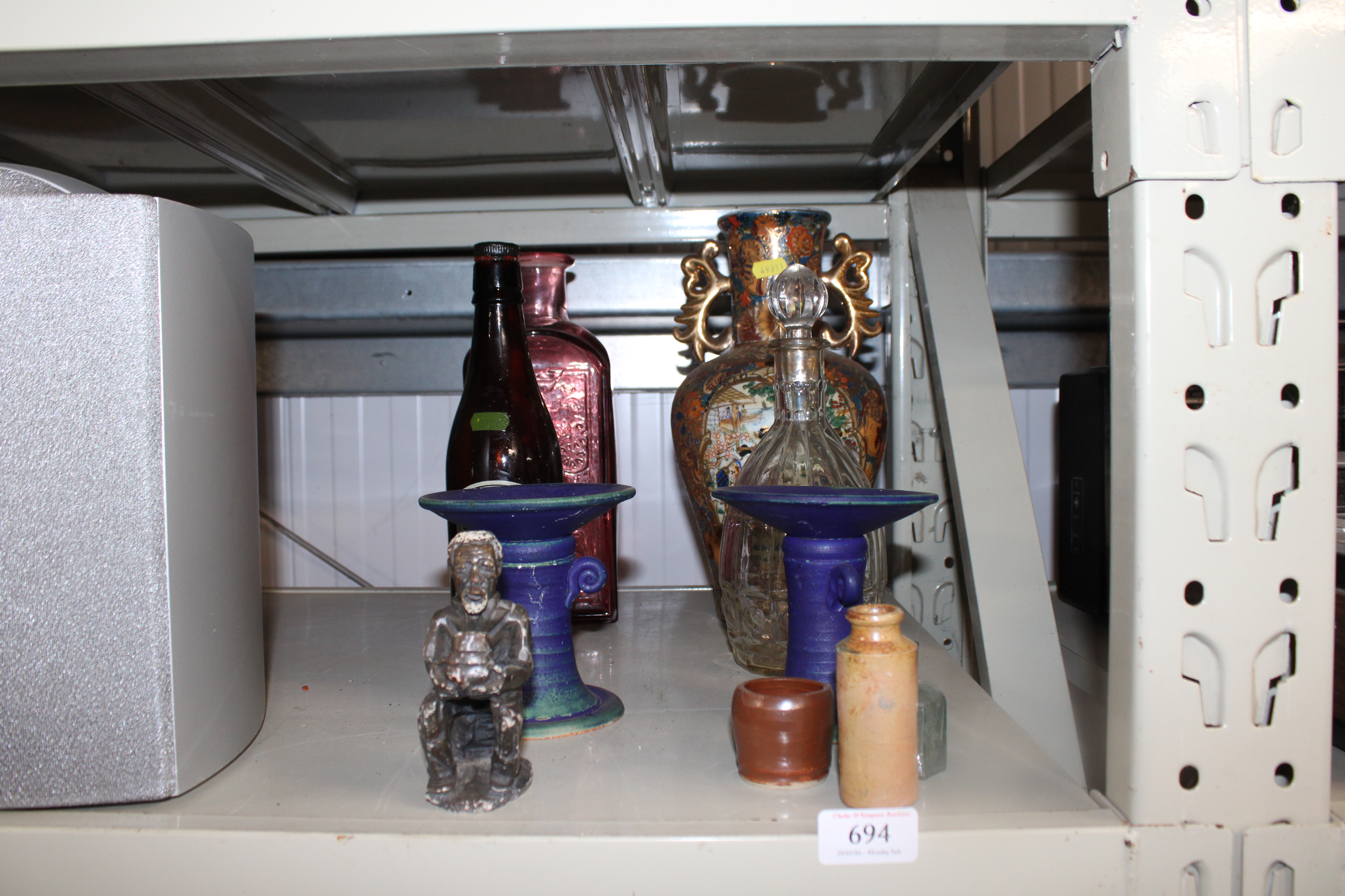 A pair of candlesticks; an ethnic figure; an Orien