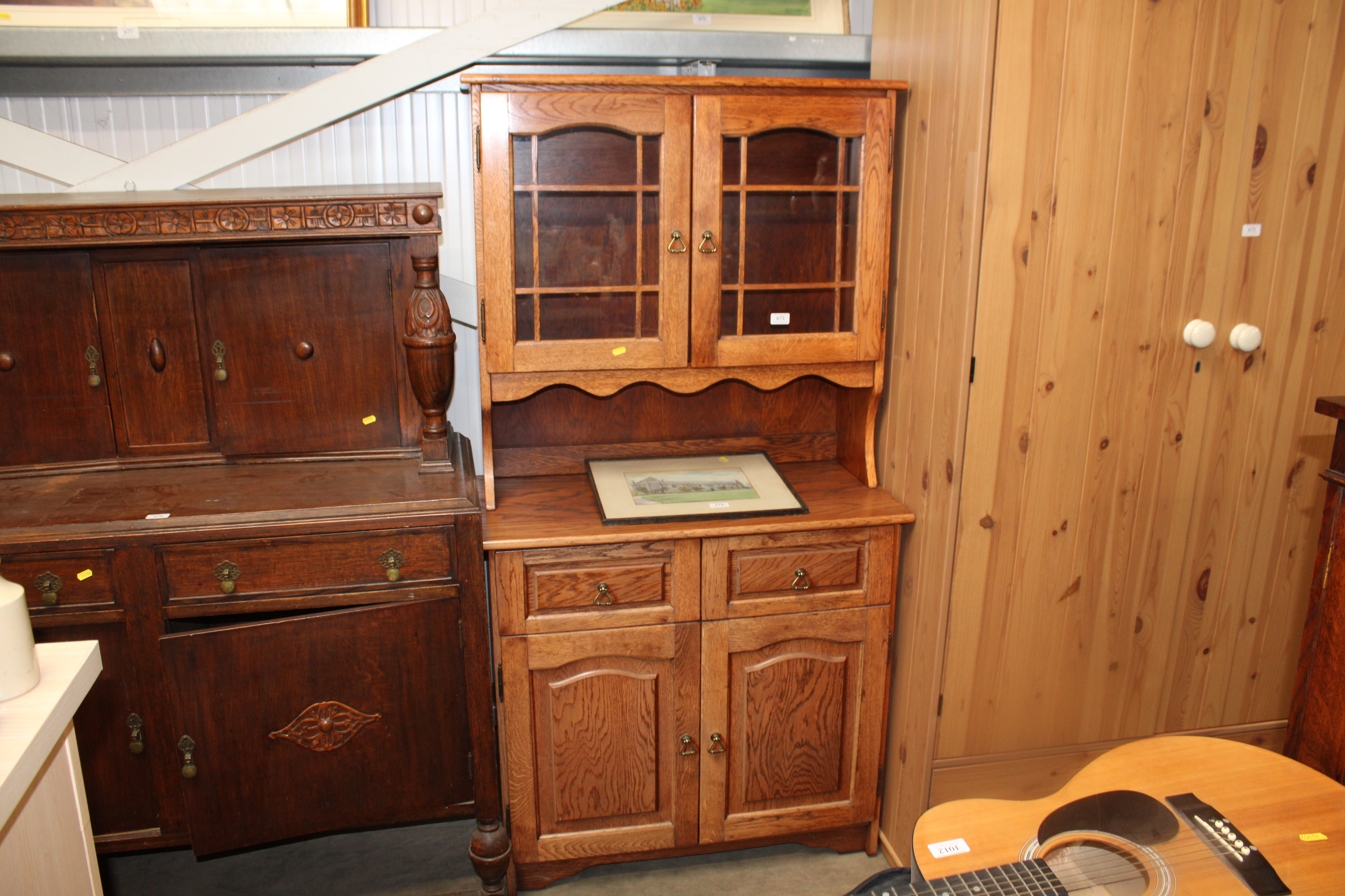 An oak dresser raised on cupboard base fitted two
