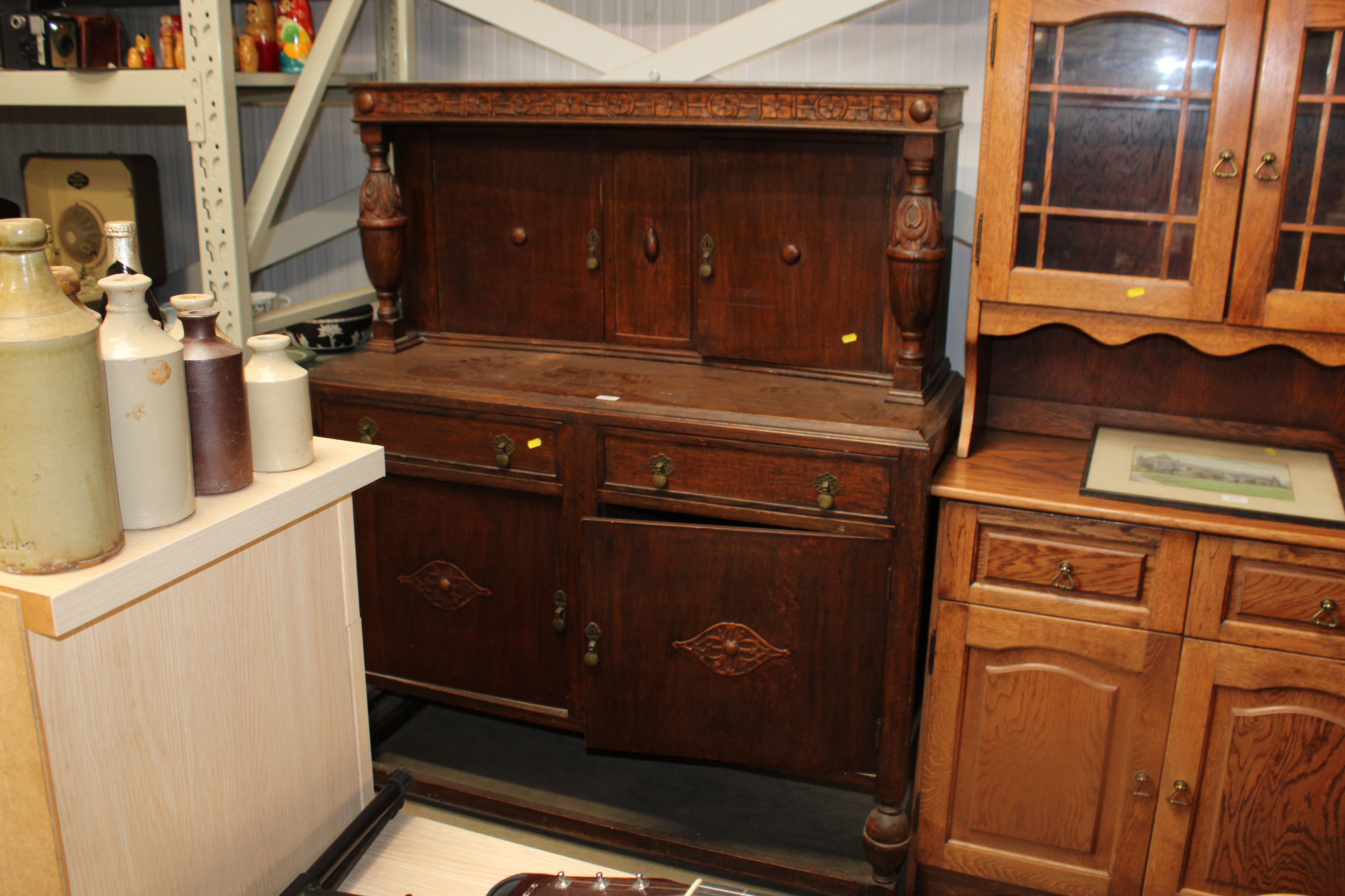 An oak court cupboard fitted two drawers