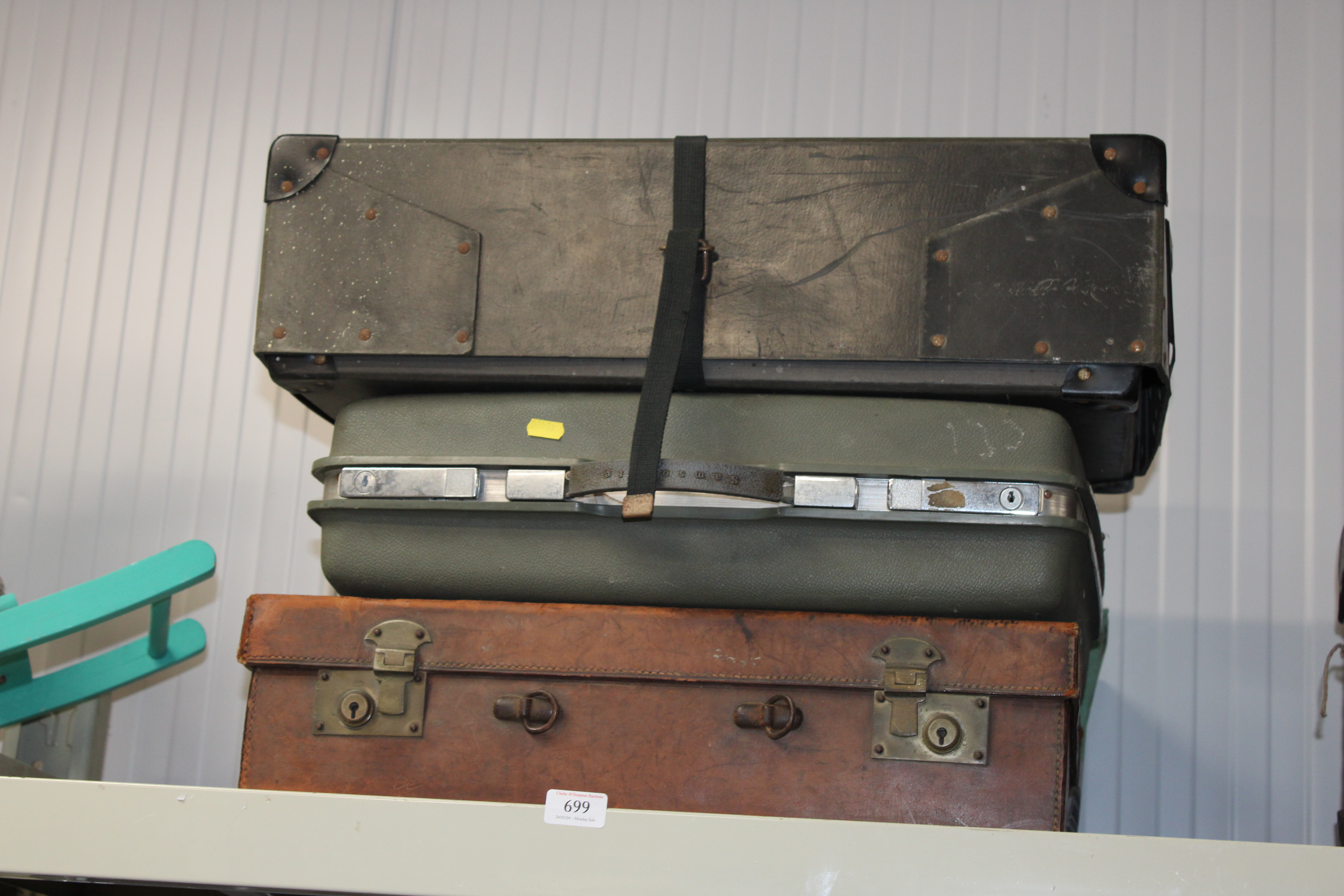 A Samsonite suitcase and two vintage travelling tr
