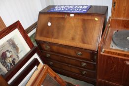 A reproduction mahogany bureau fitted three drawer