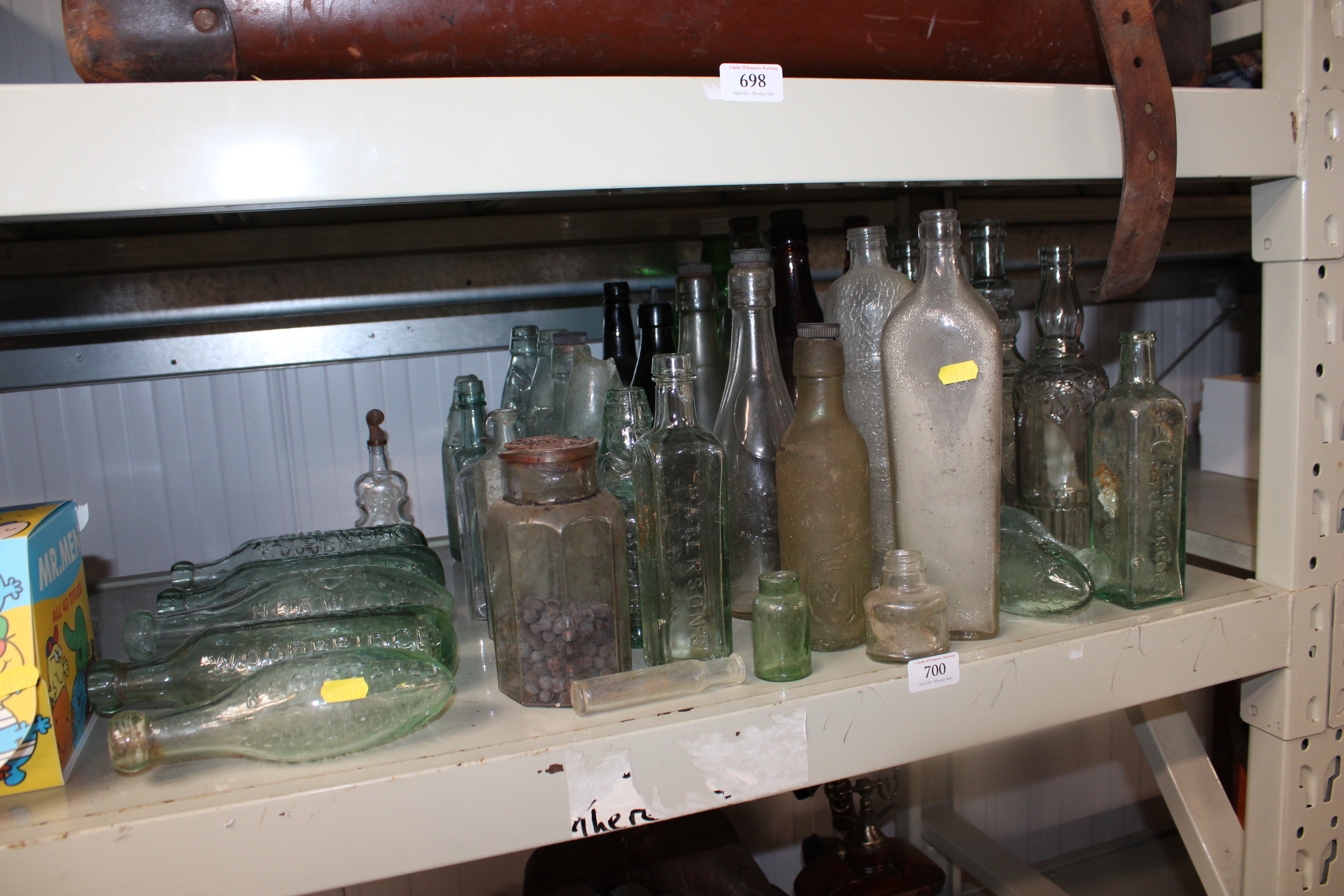 A collection of various old bottles, some relating