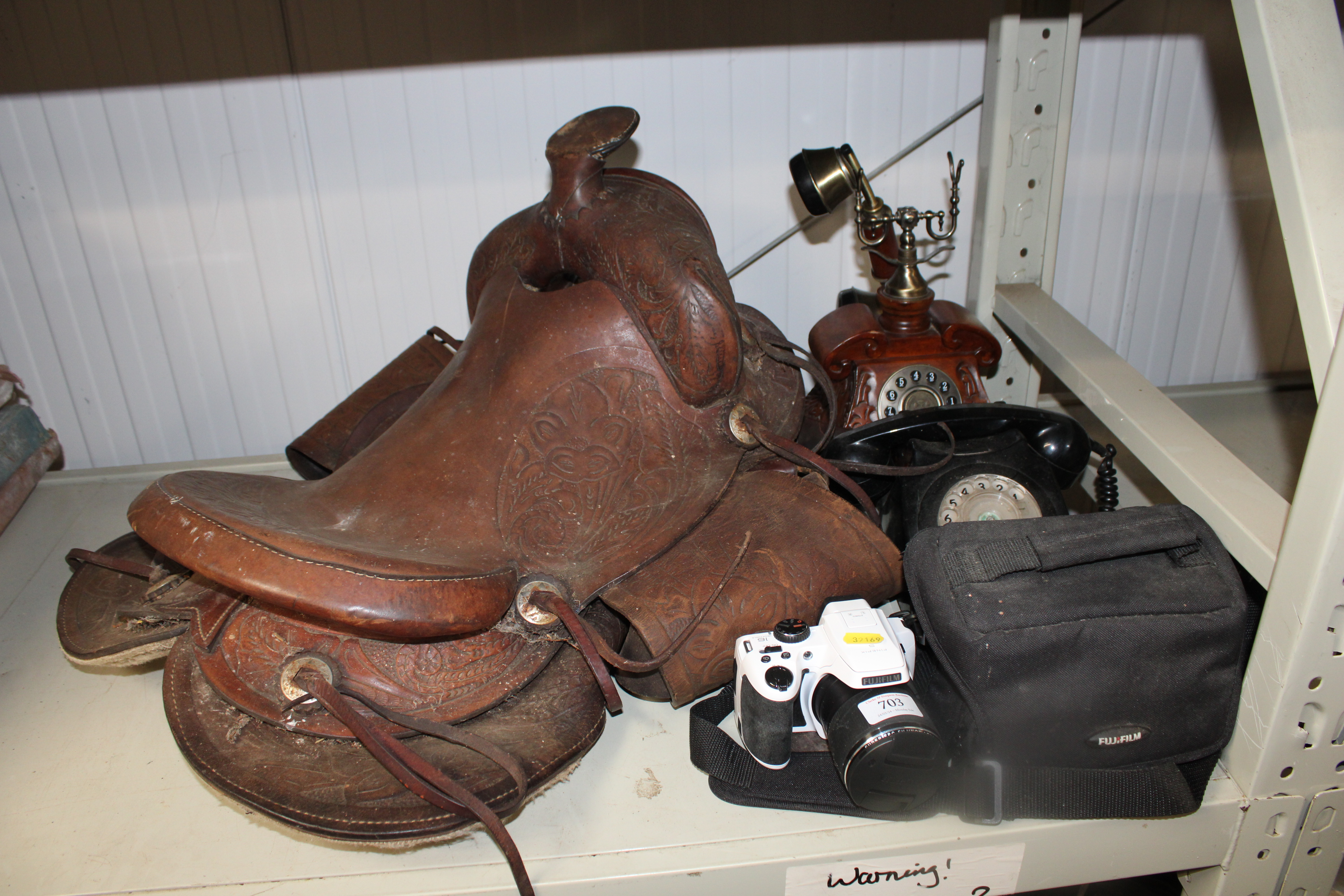 A rotary dial telephone; a wooden telephone; a Fuj