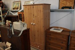 A modern pine two door wardrobe fitted single draw