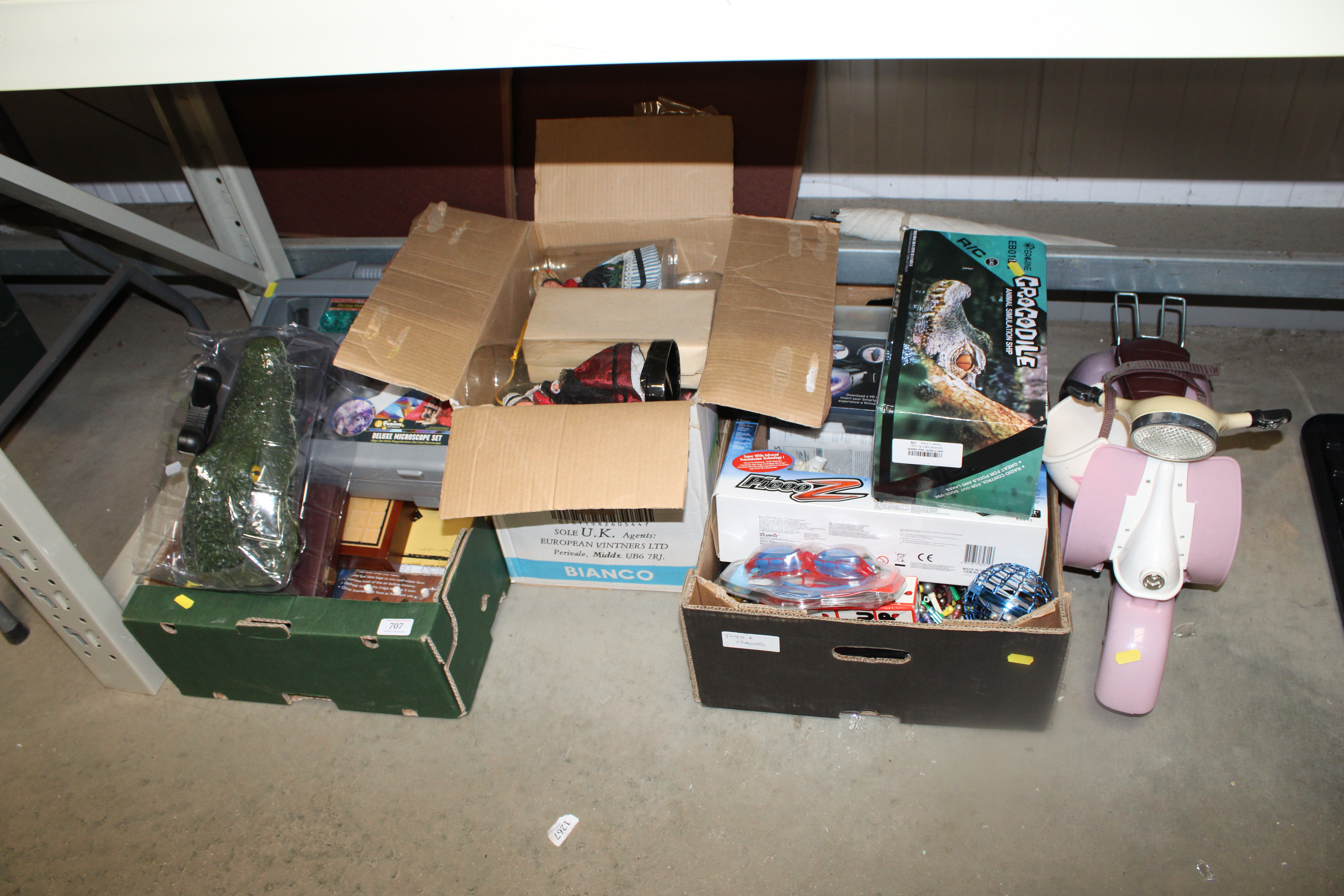 Three boxes containing various children's toys to