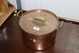 A copper and brass pot and lid