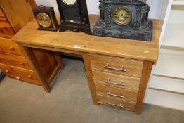A modern light oak single pedestal desk fitted fou