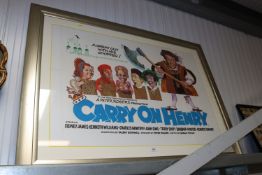 A framed and glazed 'Carry on Henry' poster