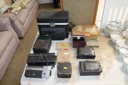 A collection of various cameras to include a Canon