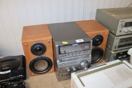 An Aiwa stereo system together with a pair of spea