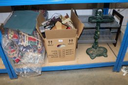 A cast iron stick stand; a box containing various