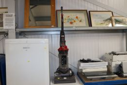 A Dyson DC33 upright vacuum cleaner