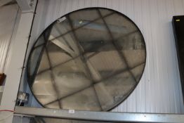 A large circular wall mirror
