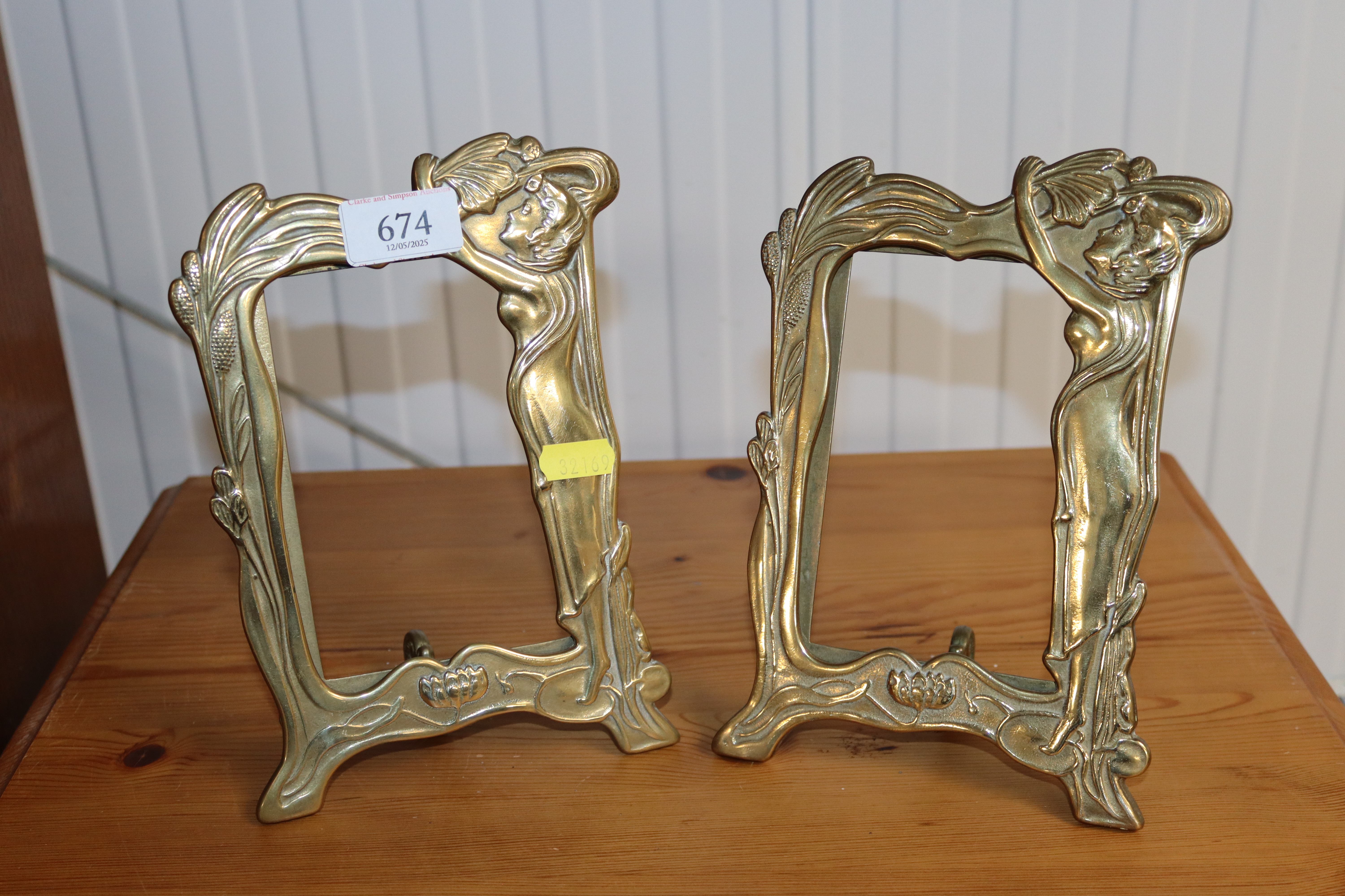 A pair of brass Art Nouveau style photo frames