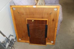 A shove ha'penny board and a Carrom board