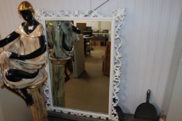 An ornate framed wall mirror