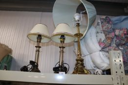 A brass table lamp and shade together with a pair