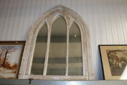 A wooden arch framed wall mirror