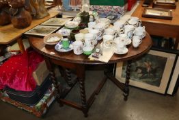 An oak gate leg table raised on barley twist suppo