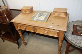 A stripped pine desk fitted two drawers