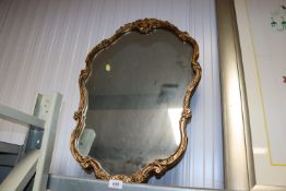 An ornate gilt framed wall mirror