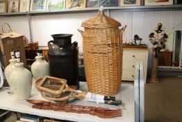 A milk churn; a wicker laundry basket; two large carved forks and various tennis racquets etc.