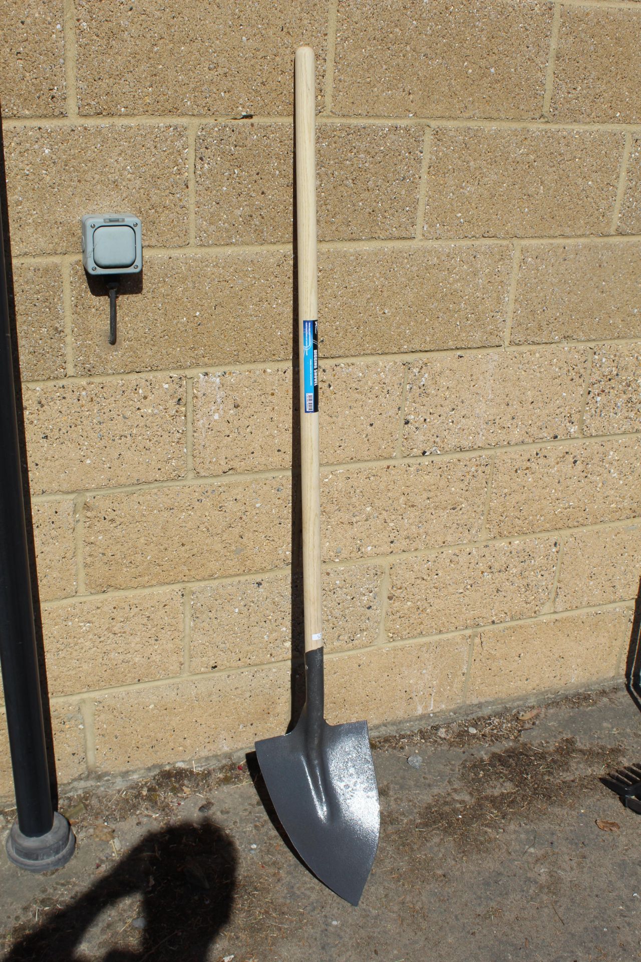 Long handled digging shovel. V