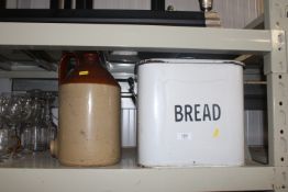 An enamel breadbin and a stoneware jug