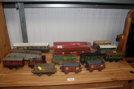 A collection of various tin model train carriages