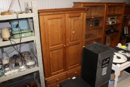 A modern pine two door wardrobe fitted two short o