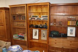 A stained pine open fronted bookcase with adjustab