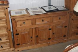A modern pine sideboard fitted three drawers