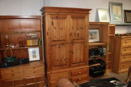 A pine two door wardrobe fitted four drawers