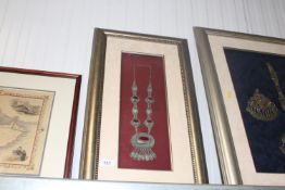 A framed and glazed study of Eastern White Metal necklace set with colour stones