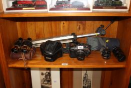 An Olympus OM20 camera, an Olympus lens, a pair of binoculars, camera tripod and a Miranda camera