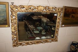 An antique pierced gilt framed wall mirror with be