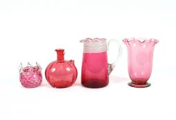 A collection of miscellaneous cranberry glassware
