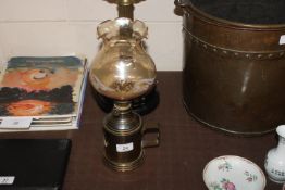 A brass hand held oil lamp