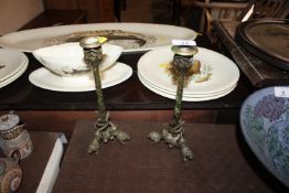A decorative pair of gilded candlesticks with lion
