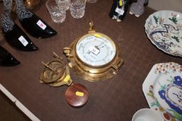 A brass bulkhead style barometer; a small reproduc
