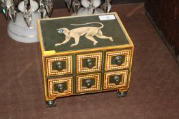 A decorative painted nest of trinket drawers, the